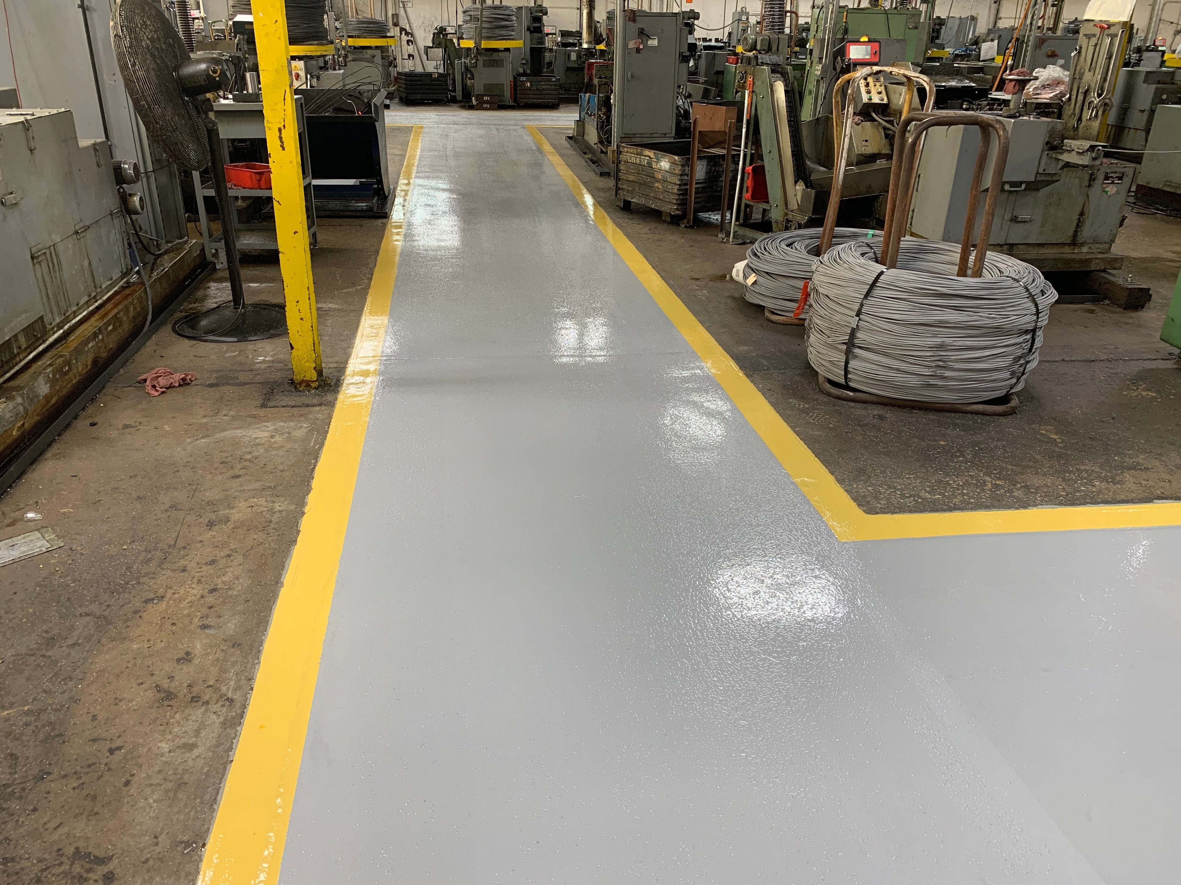 Grey epoxy drive aisle in a fasteners shop.