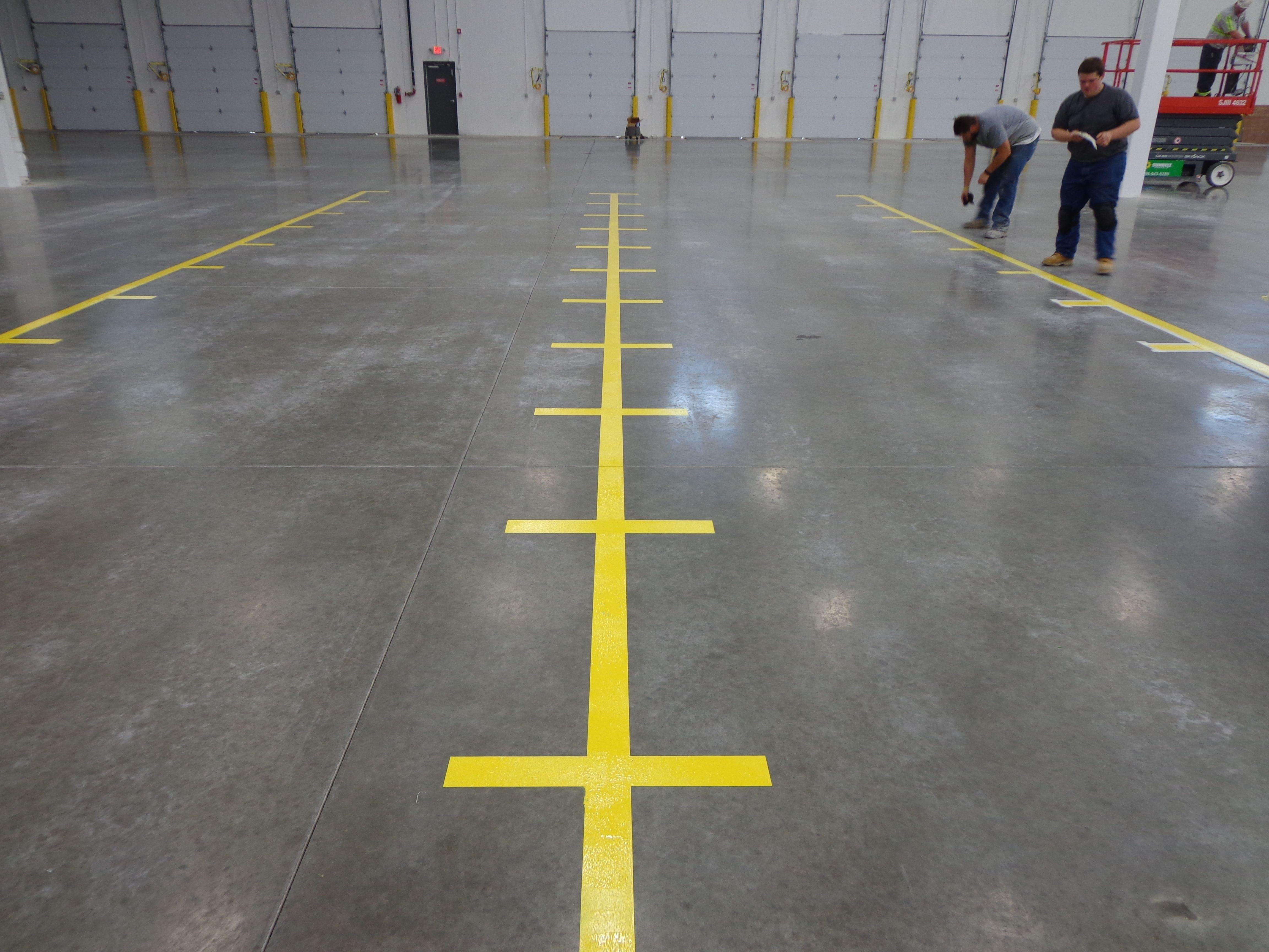 yellow bin location markings in warehouse
