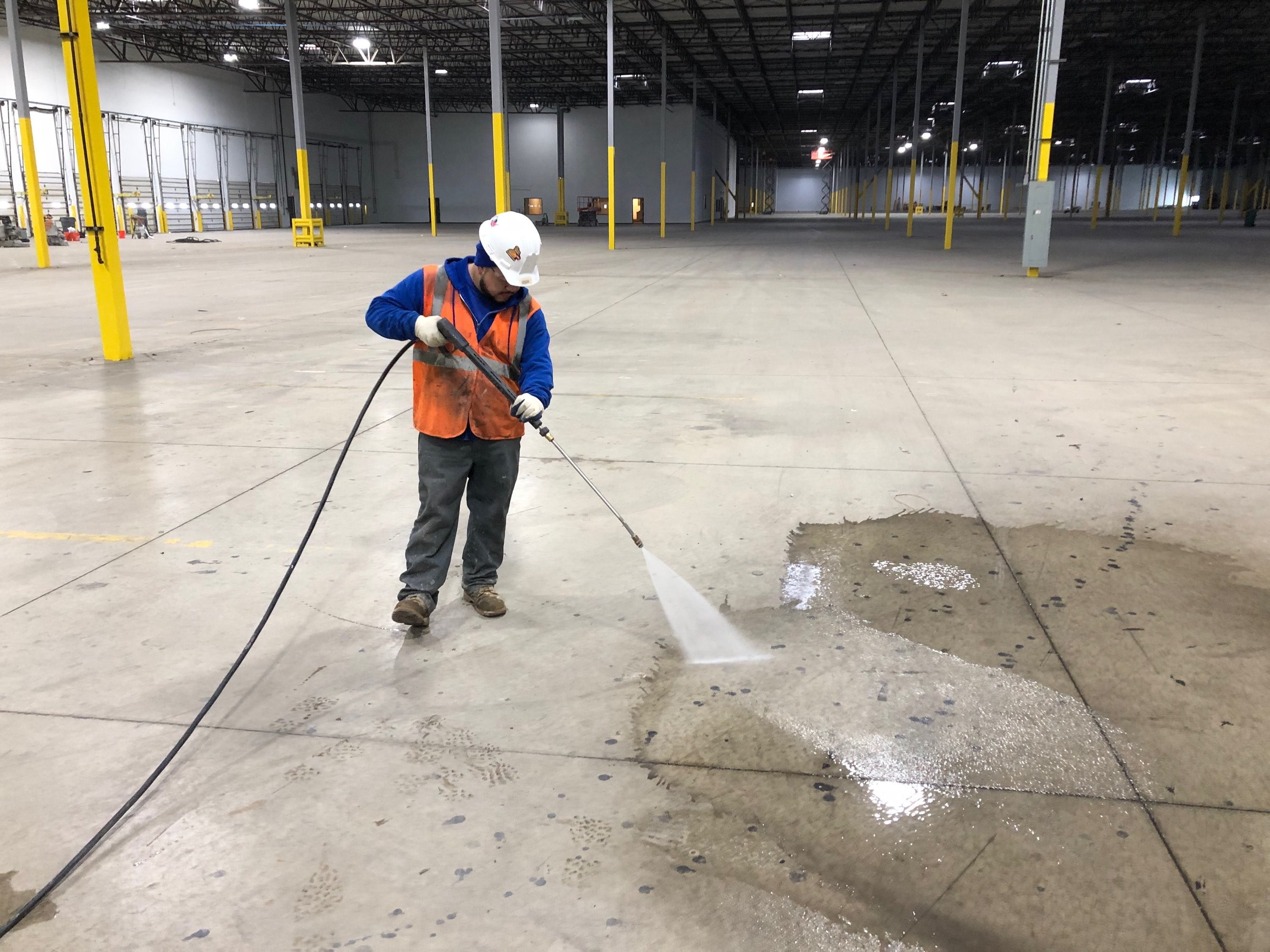 High pressure power wash of concrete